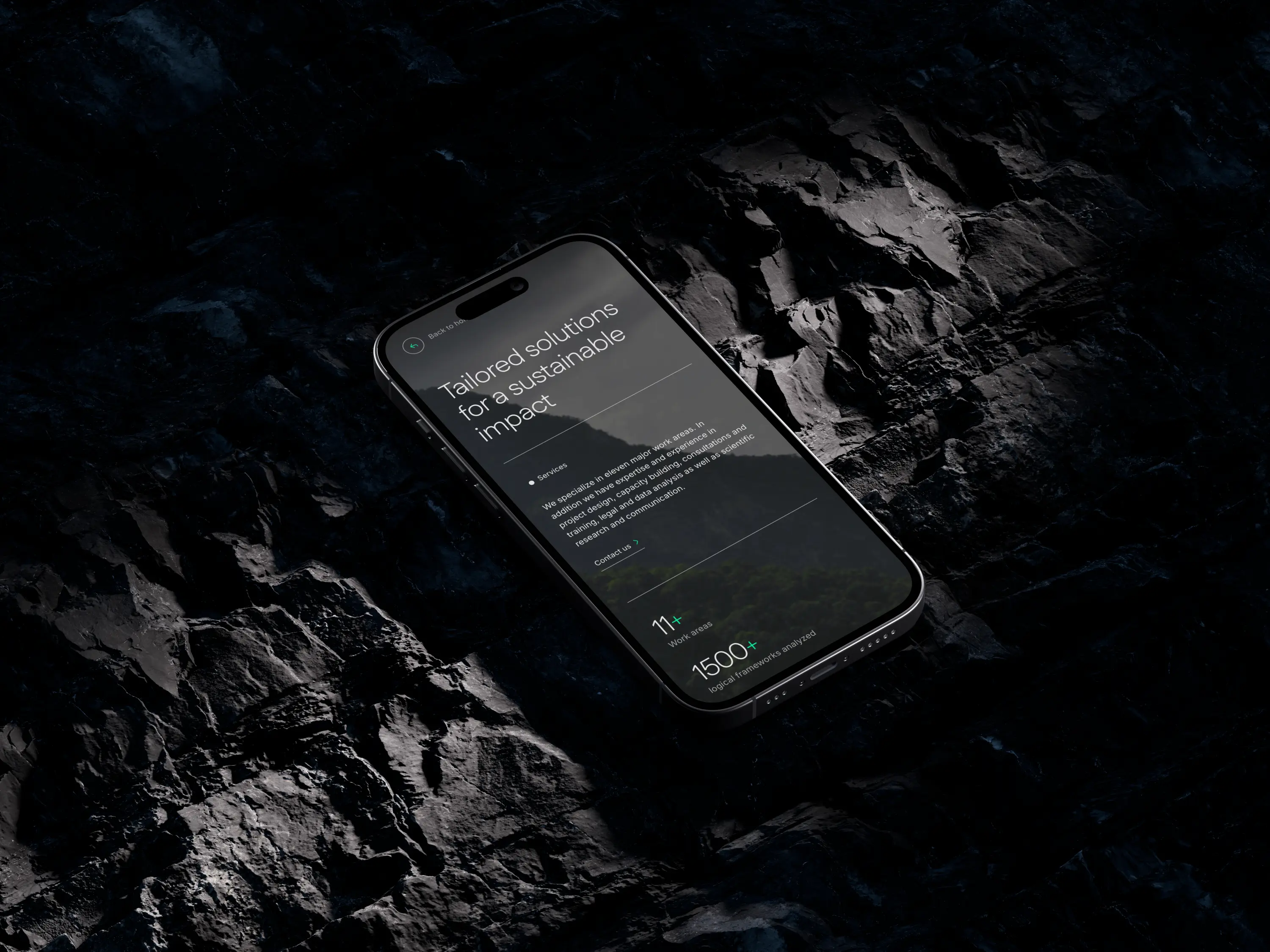 Smartphone on dark rocky surface displaying a screen with text about tailored sustainable solutions and service statistics.